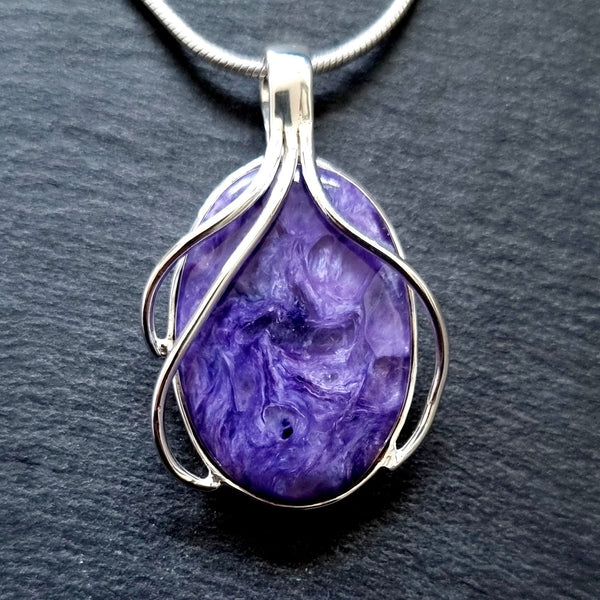 Natural Charoite gemstone displaying beautiful purple, lilac and black swirling patterns