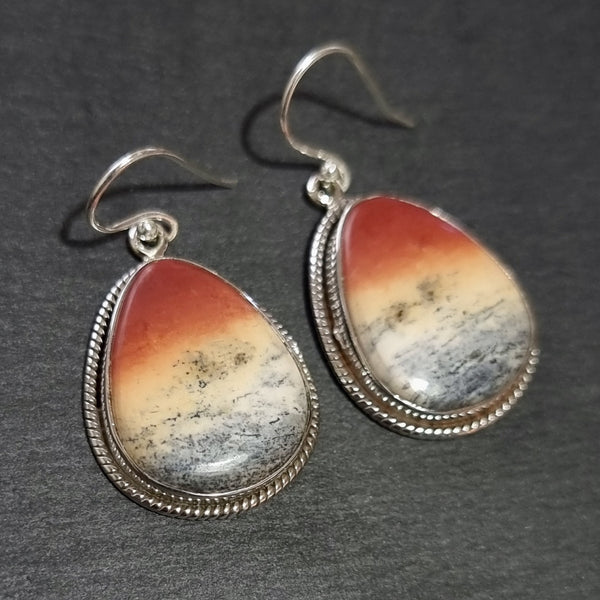 Natural Mookaite gemstone displaying rich burgundy, mustard yellow, cream and plum colours with a polished finish.