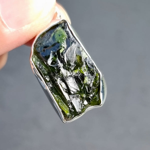 Natural Moldavite displaying its distinctive translucent green colour and characteristic textured surface formed by a meteorite impact.